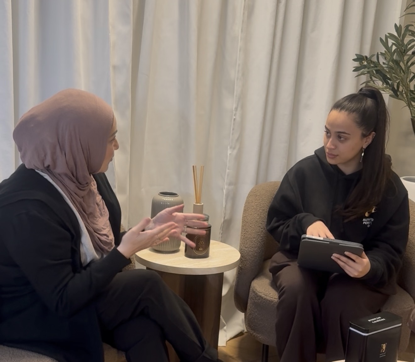 Skin therapist discussing skin concerns with a client during a consultation at Alura Skin Studio