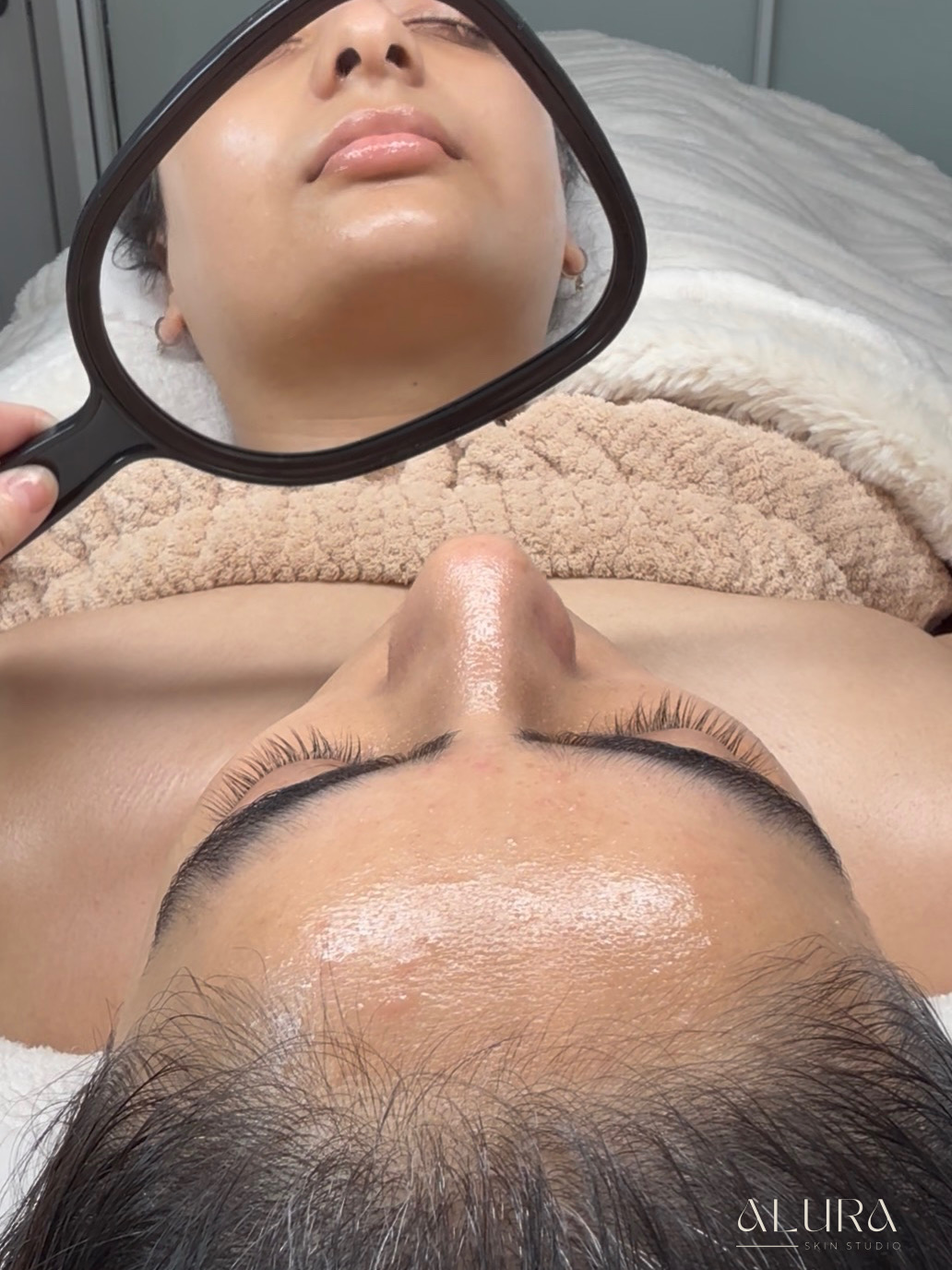 Client with glowing, freshly treated skin at Alura Skin Studio